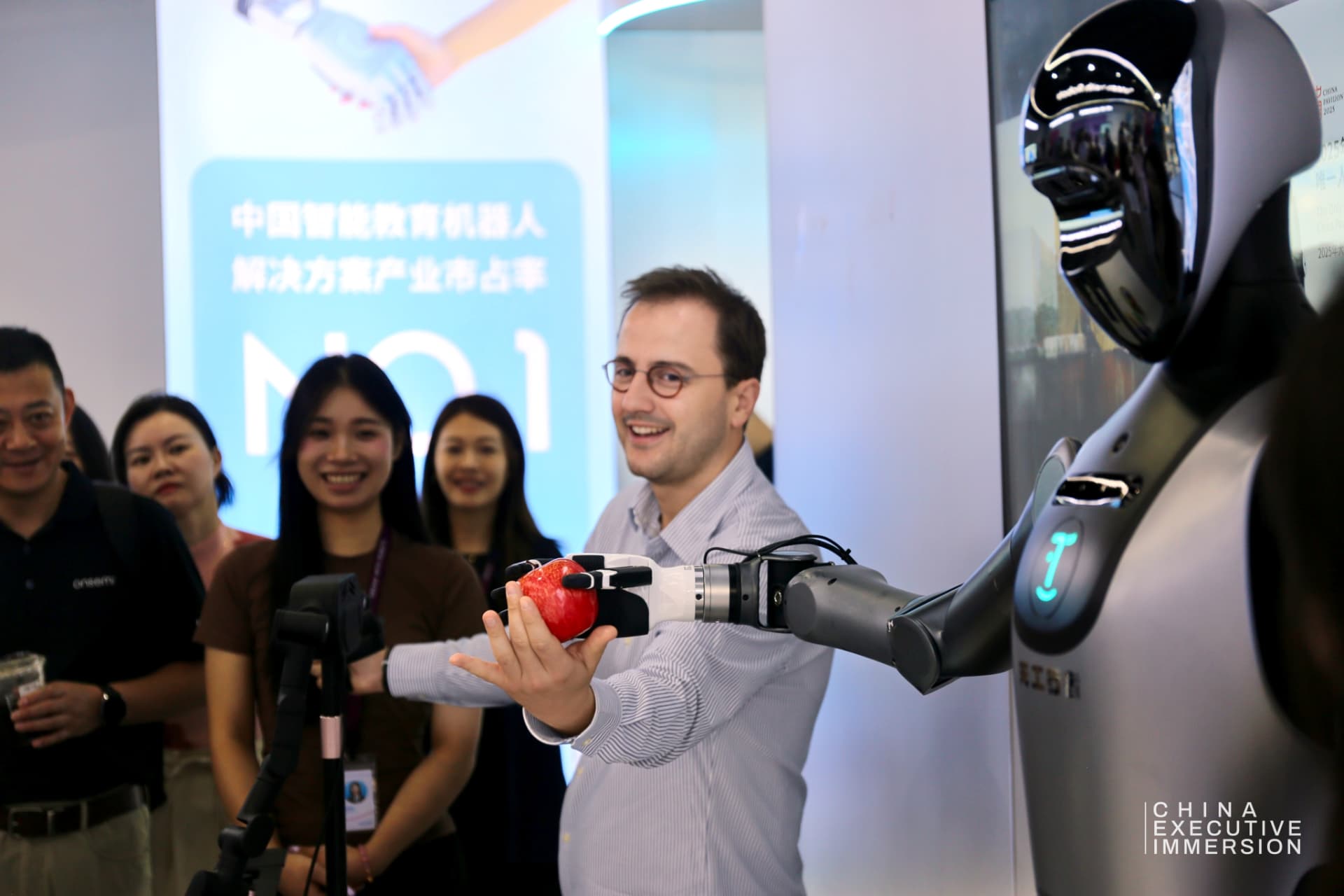 UBTECH — taking an apple from the hand of an industrial humanoid — Shenzhen